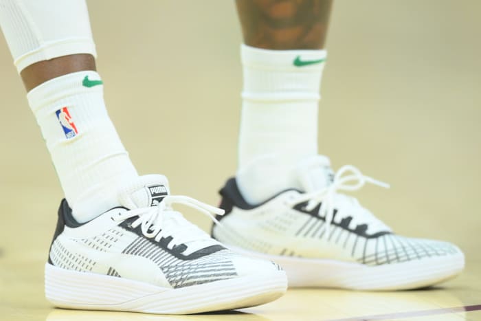 View of Dennis Schroder's white and black Puma basketball shoes.
